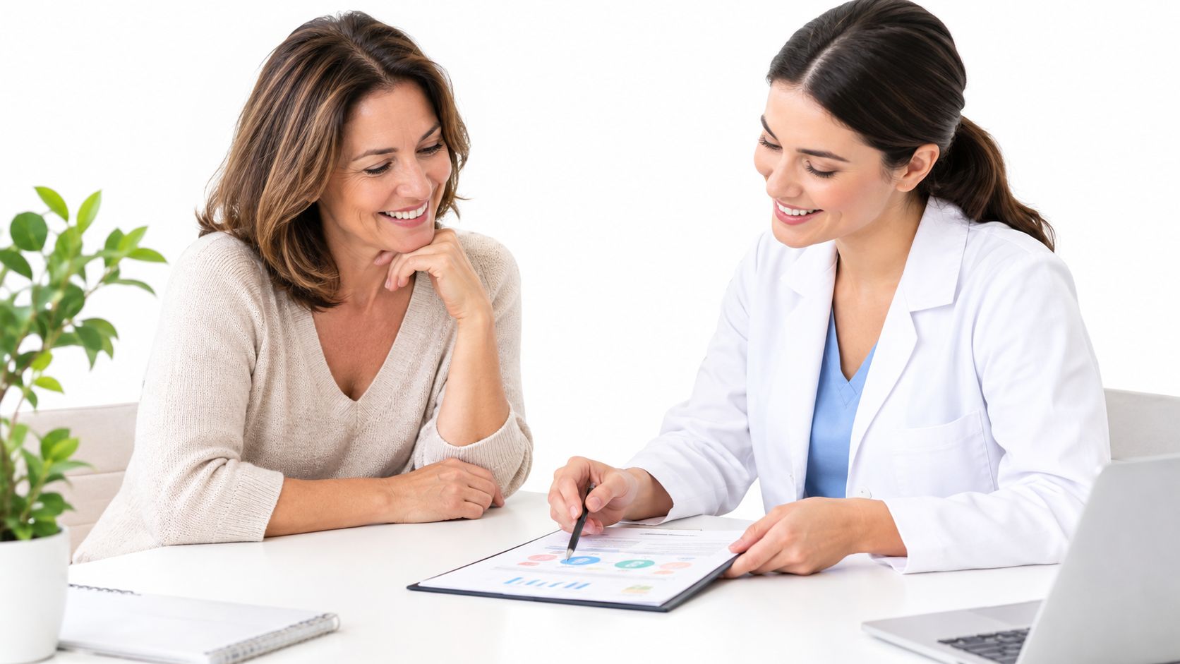 A friendly female doctor explains medical results on a document to a smiling middle-aged woman patient.